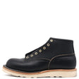 Black leather Bromley boot with brass eyelets and a white wedge sole shown unlaced from a profile view