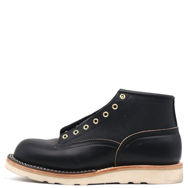 Black leather Bromley boot with brass eyelets and a white wedge sole shown unlaced from a profile view