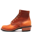 A single brown leather ankle boot with a low stacked heel, decorative metal eyelets, and a black sole, shown from a side profile on a white background.