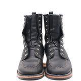 A pair of black leather lace-up ankle boots with silver metal studs and eyelets, shown from the front on a white background.