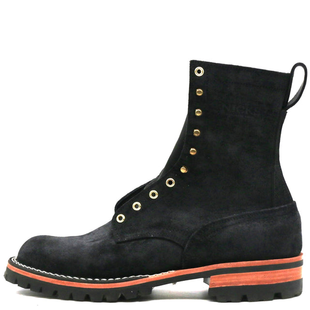 A black suede lace-up boot with gold-tone eyelets and a thick black sole featuring a vibrant orange accent stripe, shown against a plain white background.