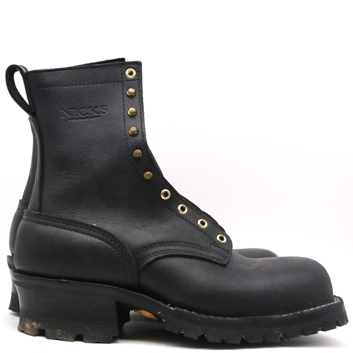 A single black leather lace-up work boot with brass eyelets and a pull tab, shown from a side profile view on a white background.