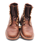A pair of brown leather lace-up ankle boots with brass eyelets and white contrast stitching, photographed against a plain white background.