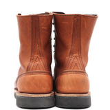 A pair of brown leather lace-up boots shown from the back, featuring decorative stitching and dark soles, set against a plain white background.