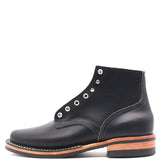 A black leather lace-up ankle boot with silver metal eyelets, a stacked black sole, and a tan leather midsole, shown from a side profile on a white background.