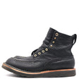 A single black leather lace-up ankle boot with gold-tone metal eyelets and stitching, shown from a side profile on a white background.