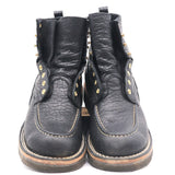 A pair of black leather ankle boots with gold-tone metal eyelets and studs, featuring contrast stitching and a tan welt, photographed against a plain white background.