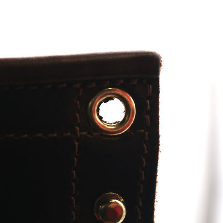 Up close photo of damaged top brass eyelet on a pair of boots.