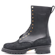 A black leather and suede lace-up boot with brass-tone metal eyelets and studs, featuring a chunky black sole and the brand name 'NICKS' embossed on the side, set against a plain white background.