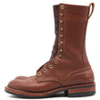 A single mid-calf brown leather boot with brass eyelets, lace loops, and pull tab, shown from a side profile on a white background.