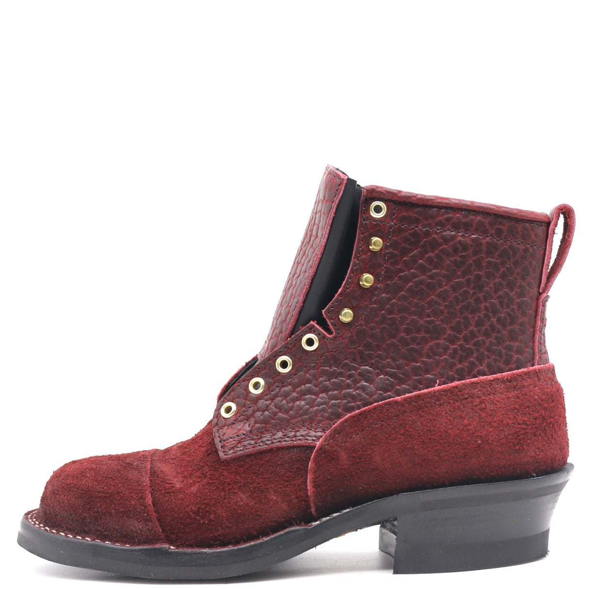 A single red leather ankle boot with a textured pebbled upper, suede toe cap, gold-tone eyelets, and a black stacked heel, shown against a plain white background.