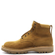 A single men's ankle boot in tan suede with dark metal eyelets, a pull tab, and a thick lug sole, shown from a side profile on a white background.