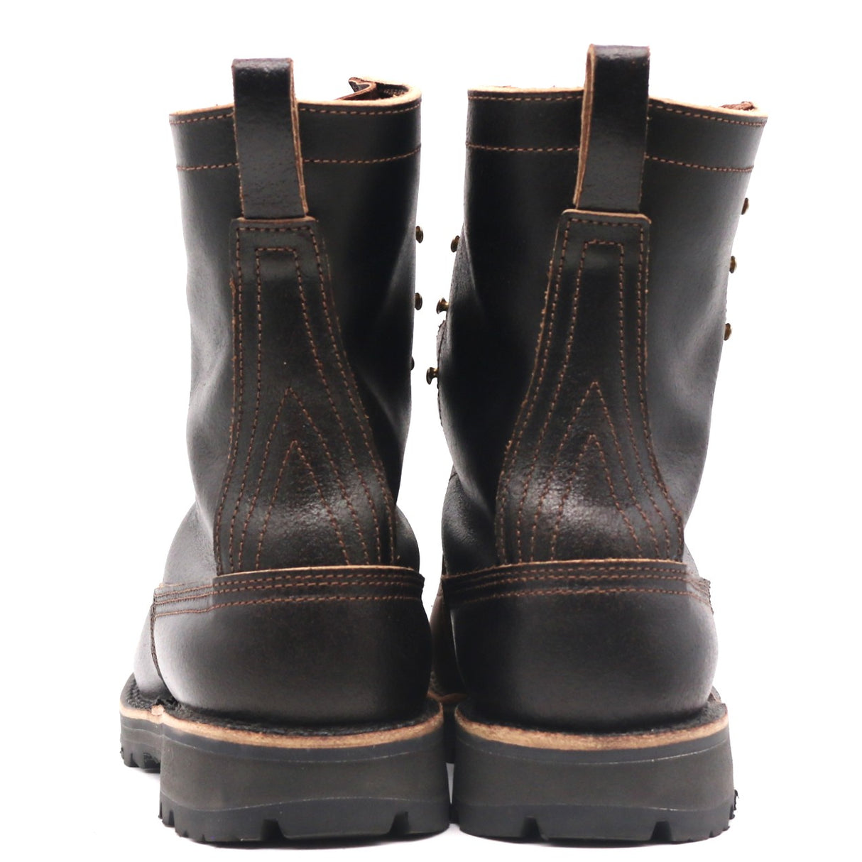 A pair of black leather work boots shown from the back, featuring contrast brown stitching, pull tabs, and thick lug soles on a white background.