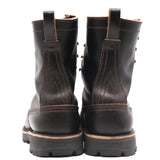 A pair of black leather work boots shown from the back, featuring contrast brown stitching, pull tabs, and thick lug soles on a white background.