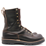 A single dark brown leather lace-up work boot with brass eyelets and a thick lug sole, shown from a side profile on a white background.