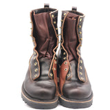 A pair of dark brown leather lace-up boots with brass grommets and studs, shown from the front against a white background.