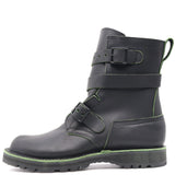 A black leather ankle boot with three adjustable straps and a rugged sole, featuring bright green contrast stitching and trim.