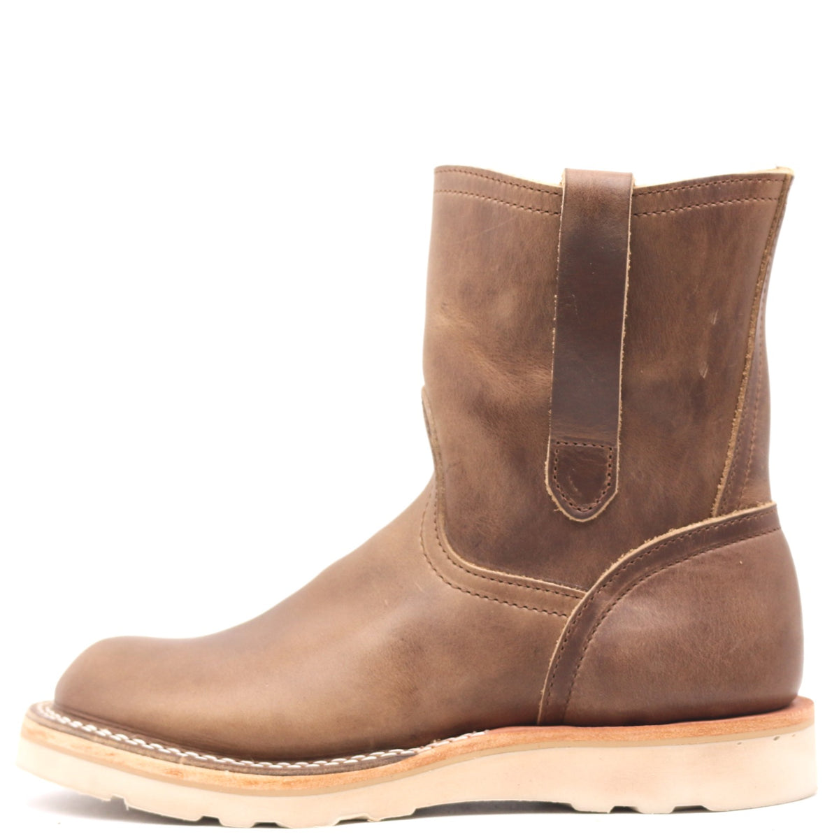 Light brown pull on boot with side pull loops and a white wedge outsole in front of a white background.