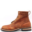 A single brown leather lace-up ankle boot with brass eyelets, shown from a side profile on a white background.