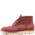 A single reddish-brown leather ankle boot with brass eyelets and a light tan sole, shown from a side profile on a white background.