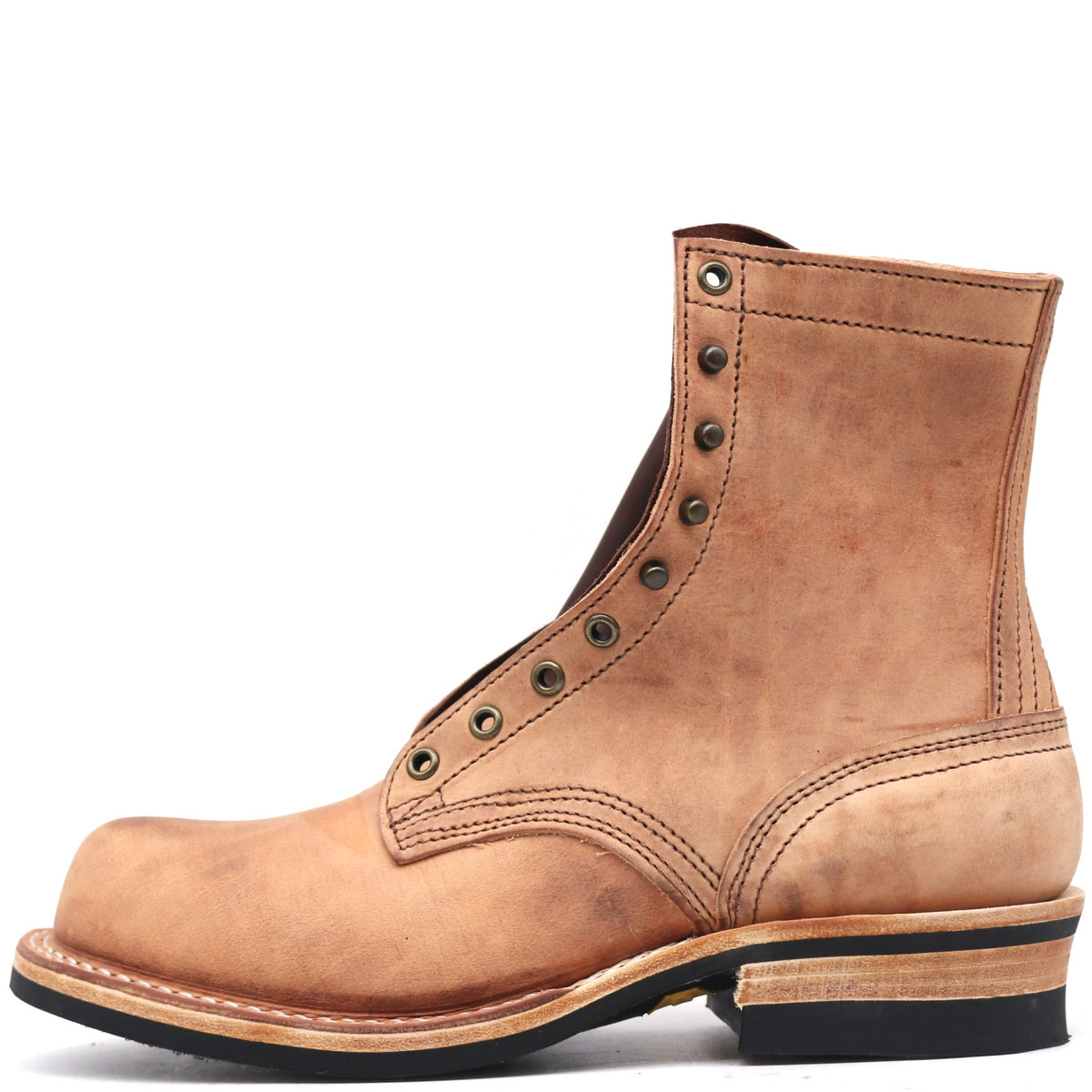 Tan boot with antique hardware in front of a white background.