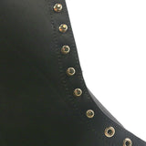 Close up of the uppers of a black boot showing the hardware. A circular indent can be seen in the leather.