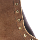 Close up of the hardware on the uppers of a pair of brown boots. Visible damage in the leather around the 3rd speedhook down.