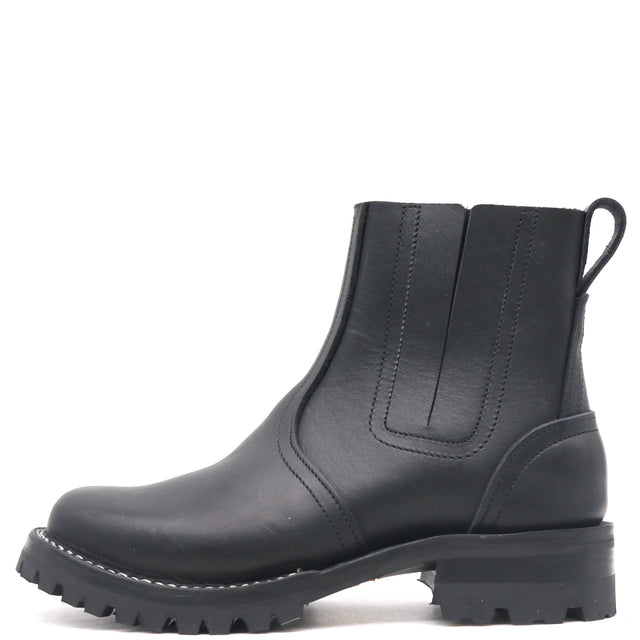 Black pull on boot with elastic Chelsea flaps, black lug outsole, and a rear pull loop in front of a white background.