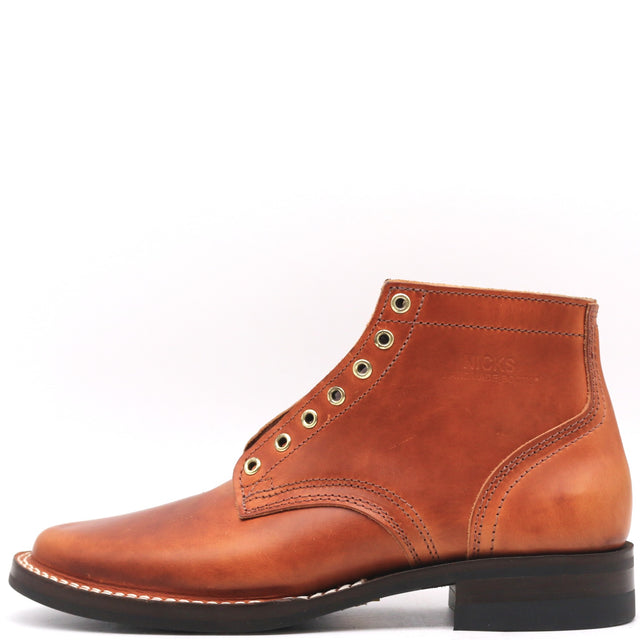 Brown dress boot with brass hardware and a 430 mini outsole in front of a white background.