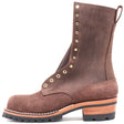 Tall brown lineman boot with lug outsole and brass hardware against a white background.