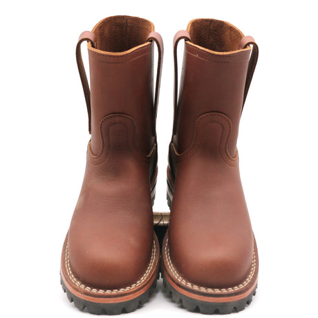 A pair of brown leather mid-calf boots with pull tabs and thick black lug soles, shown from a front-facing perspective on a white background.