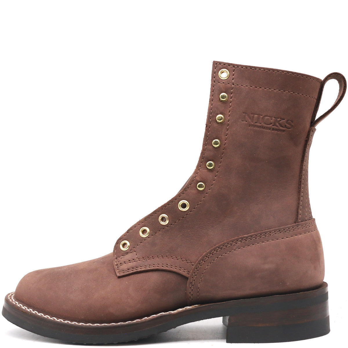 A brown suede lace-up ankle boot with brass eyelets, a pull tab, and 'NICKS' embossed on the side, shown against a plain white background.