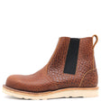 A brown textured leather Chelsea boot with a black elastic side panel and a light beige sole, shown from a side profile on a white background.