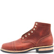 A single brown leather lace-up ankle boot with decorative metal eyelets, a cap toe, and a stacked wood-and-leather heel, shown against a plain white background.