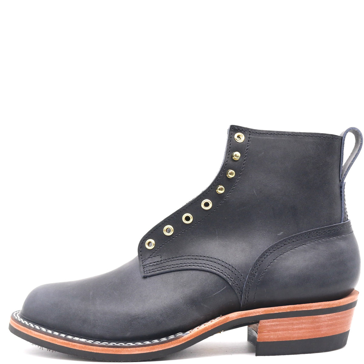 A single dark blue leather ankle boot with gold-tone metal eyelets, a pull tab, and a stacked black and brown heel, shown from a side profile on a white background.