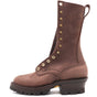 A brown leather lace-up work boot with brass eyelets, a pull tab, and a chunky dark sole, shown from the side on a white background.