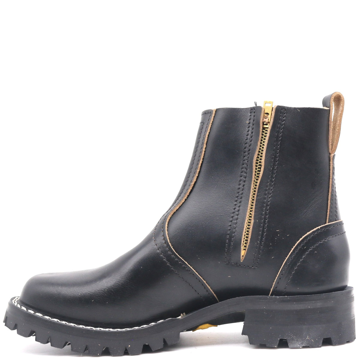 A black leather Chelsea-style ankle boot with a gold zipper, contrast stitching, and a rugged lug sole, shown from a side profile on a white background.