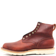 Reddish brown ankle boot with rear pull loop, brass hardware, and white wedge outsole in front of a white background.