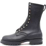 A black leather lace-up boot with gold-tone metal eyelets and studs, featuring a pull tab and the brand name 'NICKS' embossed on the side, shown against a plain white background.