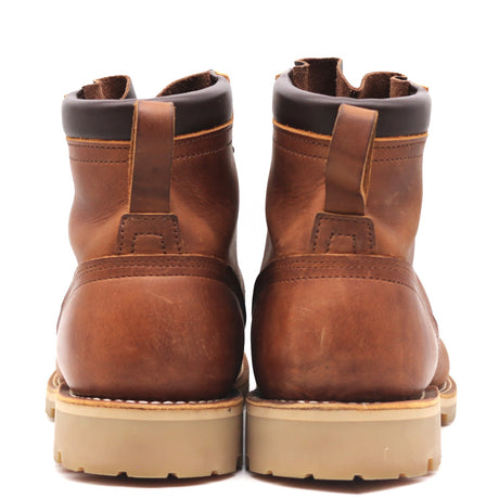 A pair of brown leather ankle boots shown from the back, featuring pull tabs, dark brown collar trim, and thick tan soles, set against a plain white background.