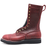 Tall red texture bison leather boot with rear pull loop and brass hardware in front of a white background.