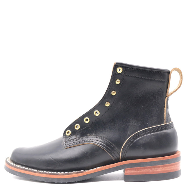 A black leather lace-up ankle boot with brass eyelets, contrast stitching, and a stacked brown and black sole, shown from a side profile on a white background.