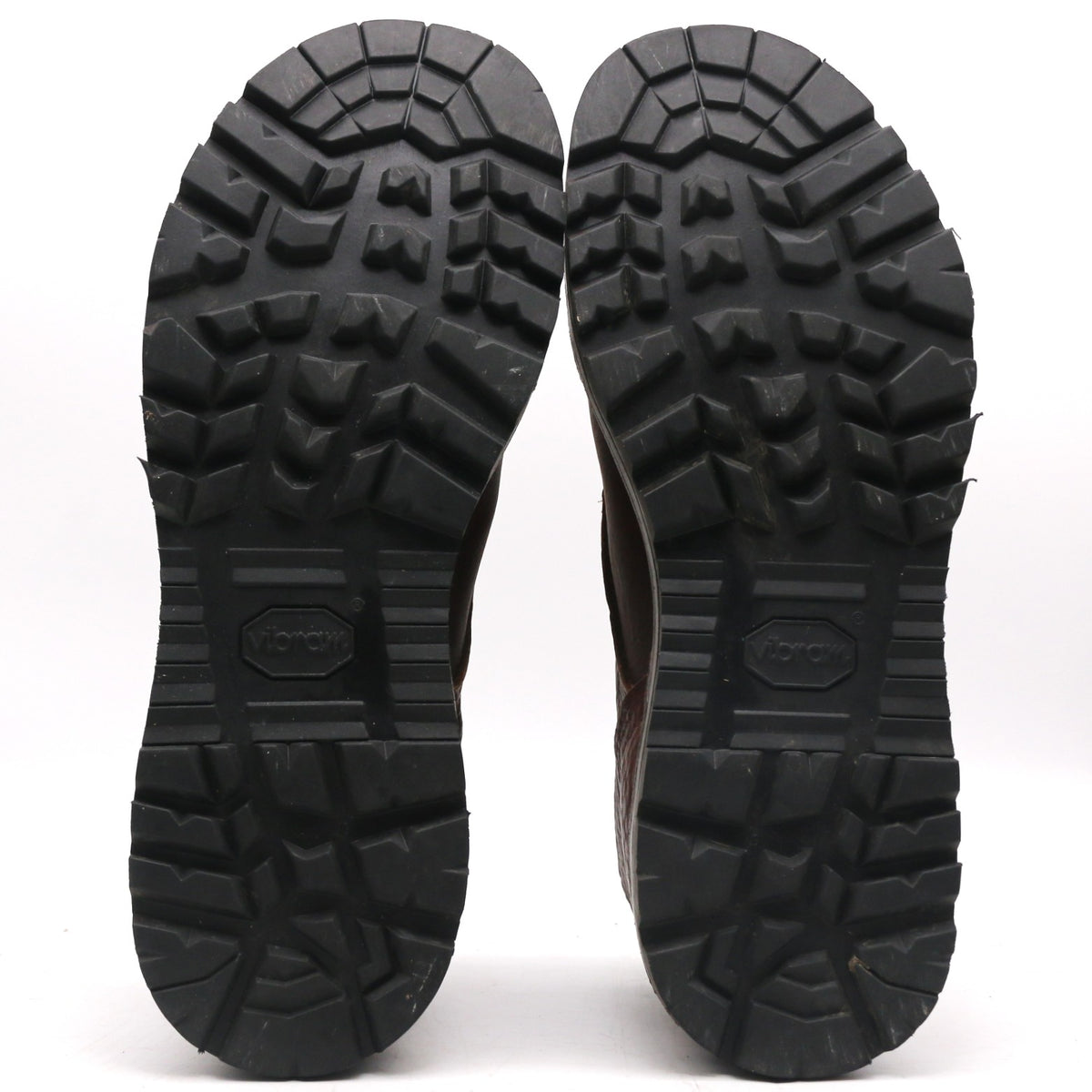 The treaded black rubber soles of a pair of boots, shown from the bottom against a plain white background. The Volar logo is embossed in the center of each sole.