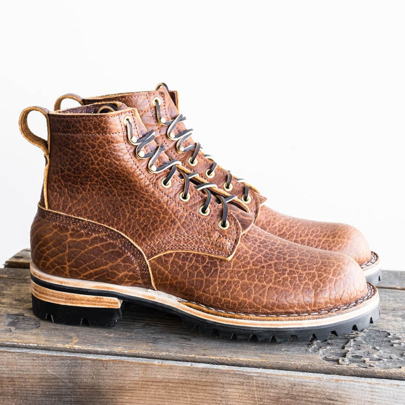 Brown textured bison leather lace-up work boots with speed hooks and lug soles